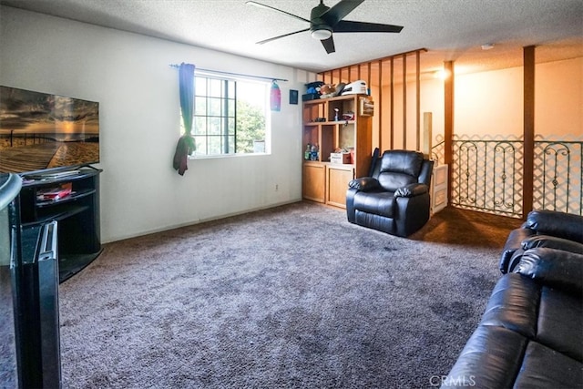 living area featuring carpet flooring, ceiling fan, and a textured ceiling