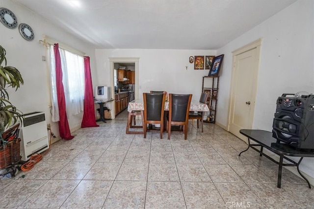 dining room with heating unit and light tile patterned floors