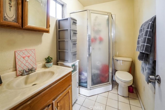 bathroom featuring a stall shower, tile patterned flooring, vanity, and toilet