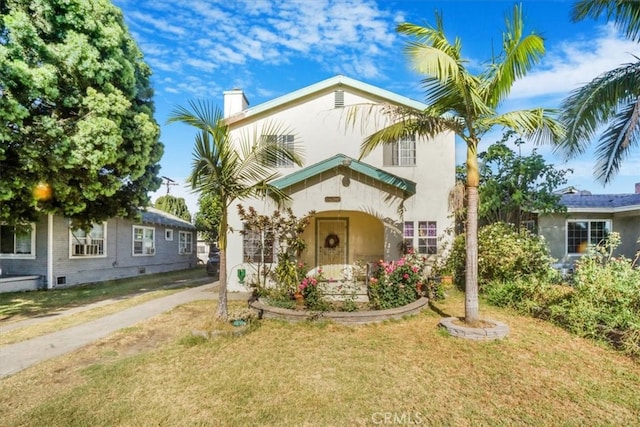 mediterranean / spanish-style home featuring a front yard