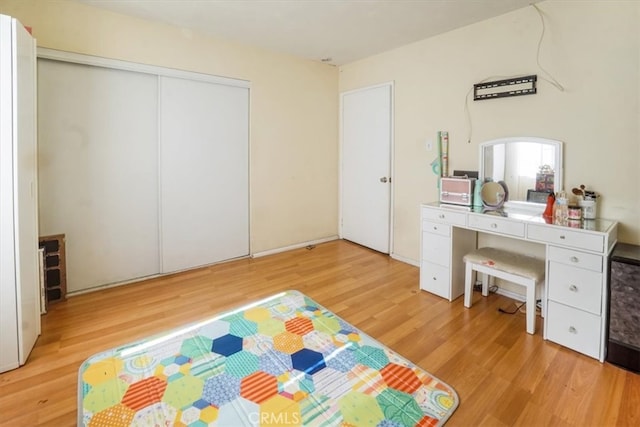 bedroom with a closet and light wood-style floors