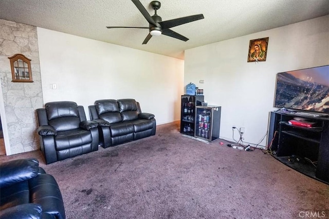 carpeted living room with ceiling fan and a textured ceiling