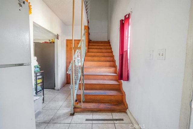 staircase featuring tile patterned floors