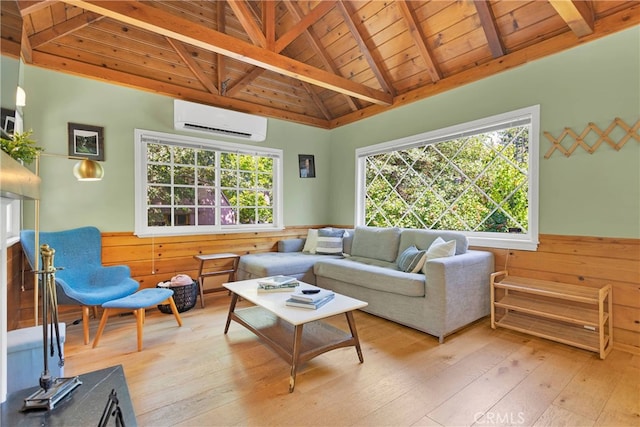 living room with a wall unit AC, a wealth of natural light, and light hardwood / wood-style floors