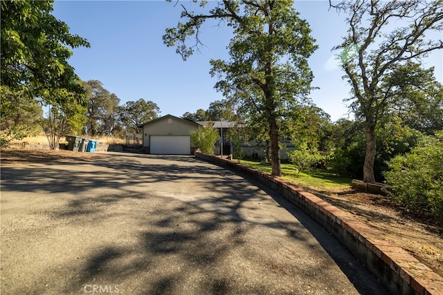 ranch-style house with a garage and an outbuilding