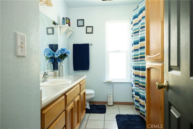 bathroom featuring vanity, tile patterned flooring, and toilet