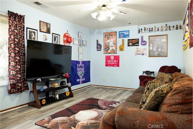 living room featuring ceiling fan and light hardwood / wood-style flooring