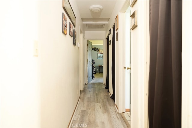 hall with light hardwood / wood-style flooring