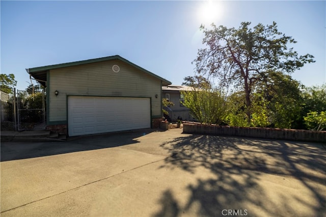 view of side of home featuring a garage