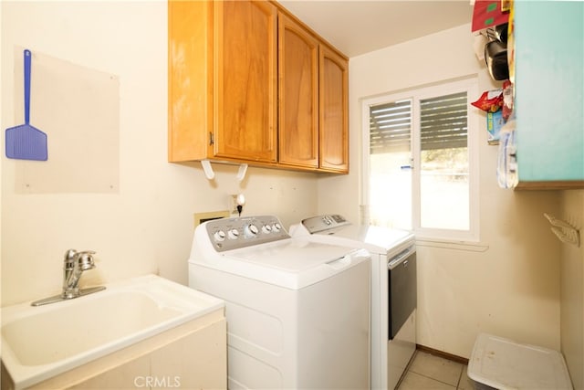 washroom with cabinets, independent washer and dryer, sink, and light tile patterned floors