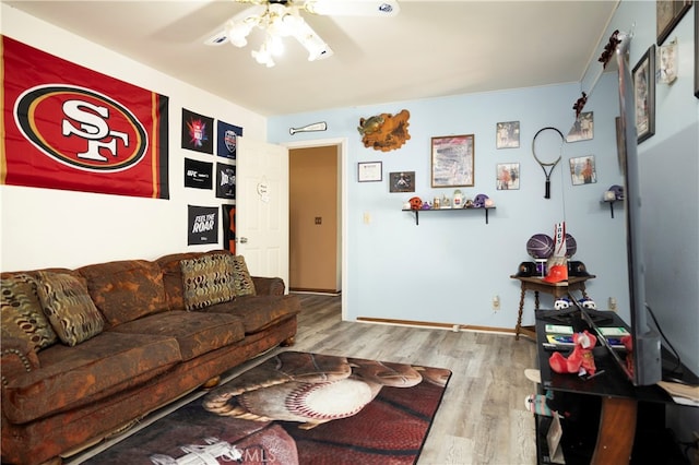 living room featuring light hardwood / wood-style floors and ceiling fan