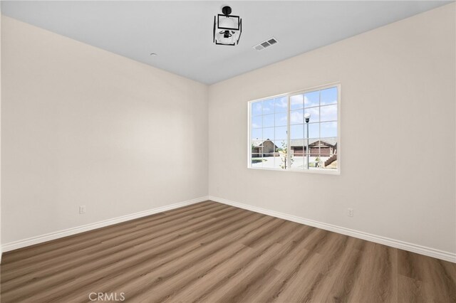 unfurnished room featuring hardwood / wood-style flooring