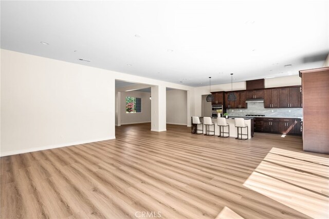 unfurnished living room with light hardwood / wood-style flooring