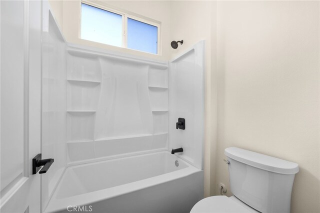 bathroom featuring shower / bath combination and toilet