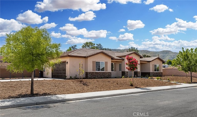 ranch-style house with a mountain view and a garage