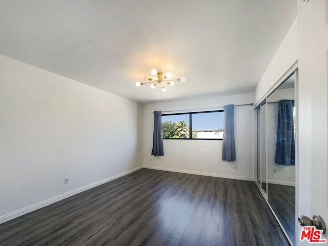 interior space featuring a chandelier and dark wood-type flooring