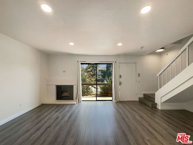 unfurnished living room featuring dark hardwood / wood-style flooring