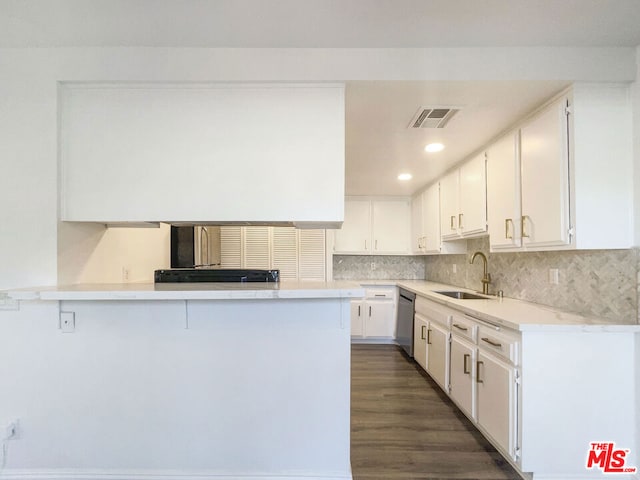 kitchen with white cabinets, sink, kitchen peninsula, dishwasher, and dark hardwood / wood-style floors