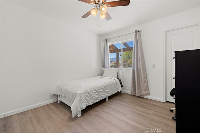 bedroom with light wood-type flooring and ceiling fan