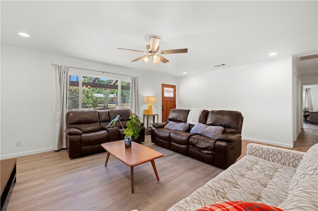 living room featuring light hardwood / wood-style floors and ceiling fan