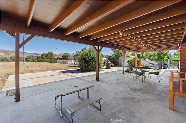 view of patio featuring a shed and a mountain view