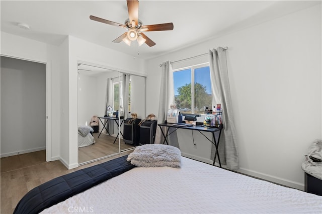 bedroom with ceiling fan, light wood-type flooring, and a closet