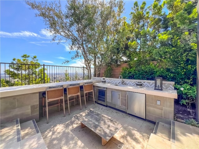 view of patio / terrace featuring wine cooler and a wet bar