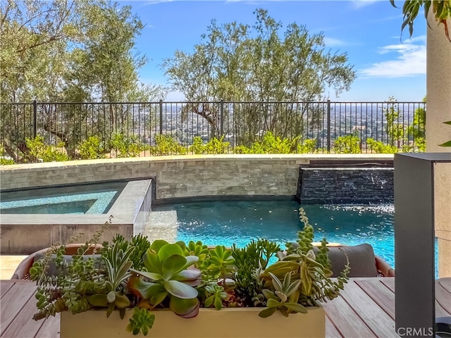 view of swimming pool featuring an in ground hot tub