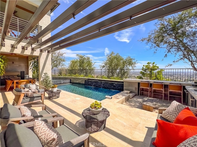 view of pool featuring pool water feature, a pergola, exterior bar, and a patio area