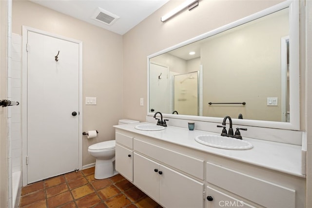 bathroom with vanity, toilet, and an enclosed shower