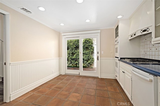 kitchen with white cabinets, white appliances, backsplash, extractor fan, and ornamental molding