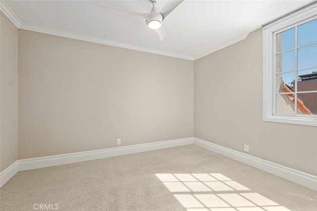 carpeted empty room with ceiling fan and crown molding