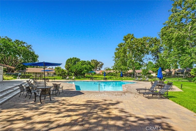 view of swimming pool featuring a patio area