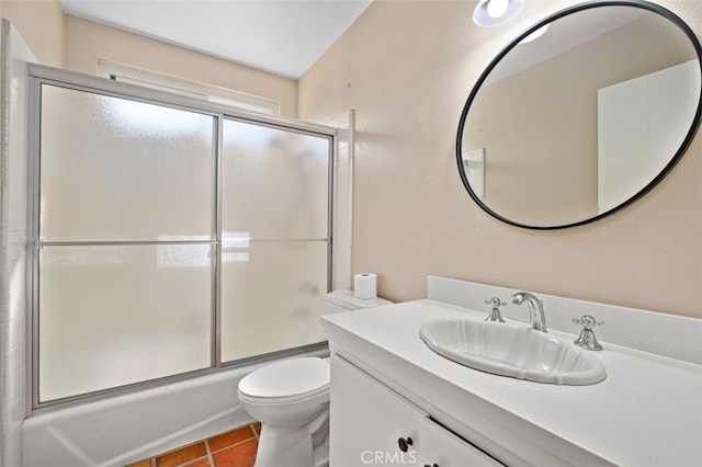 full bathroom featuring enclosed tub / shower combo, vanity, toilet, and tile patterned floors