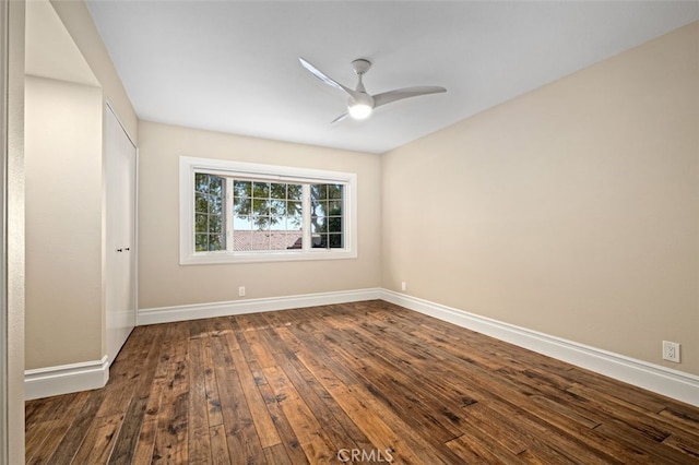 empty room featuring ceiling fan and dark wood-type flooring