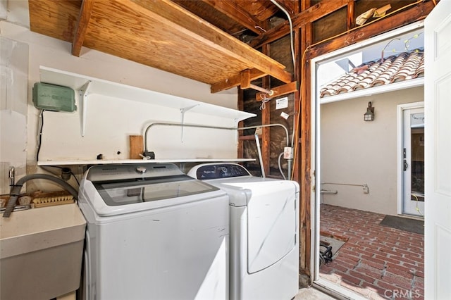 laundry area featuring washer and clothes dryer and sink