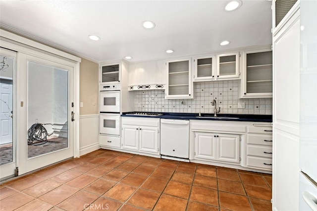 kitchen featuring white cabinetry, sink, white appliances, and decorative backsplash