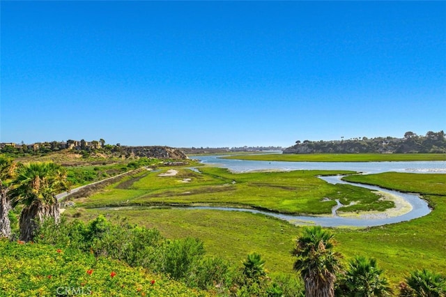 view of home's community with a yard and a water view