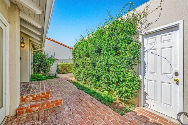 entrance to property featuring a patio area