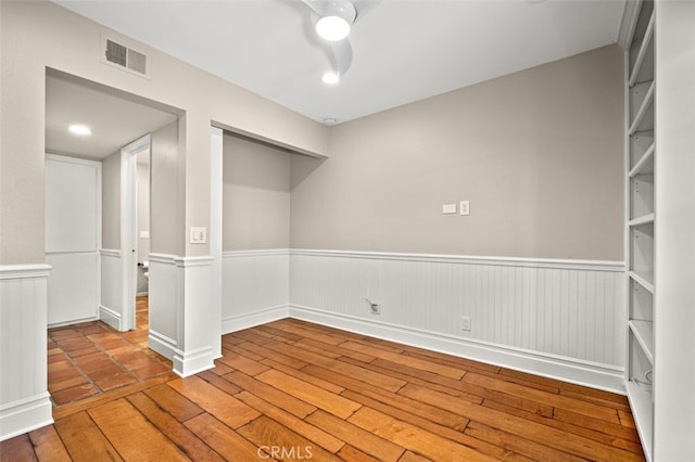 empty room featuring wood-type flooring and ceiling fan