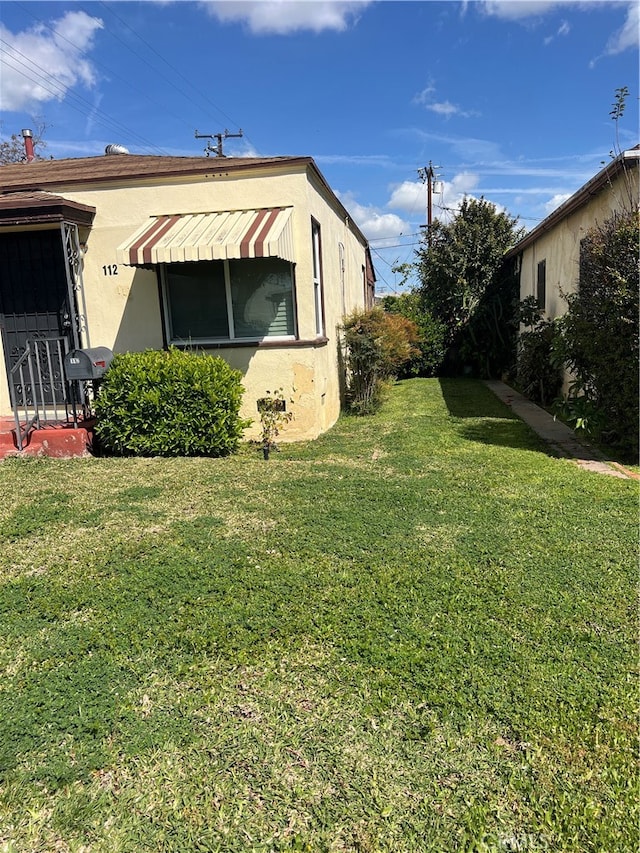 view of home's exterior with a lawn