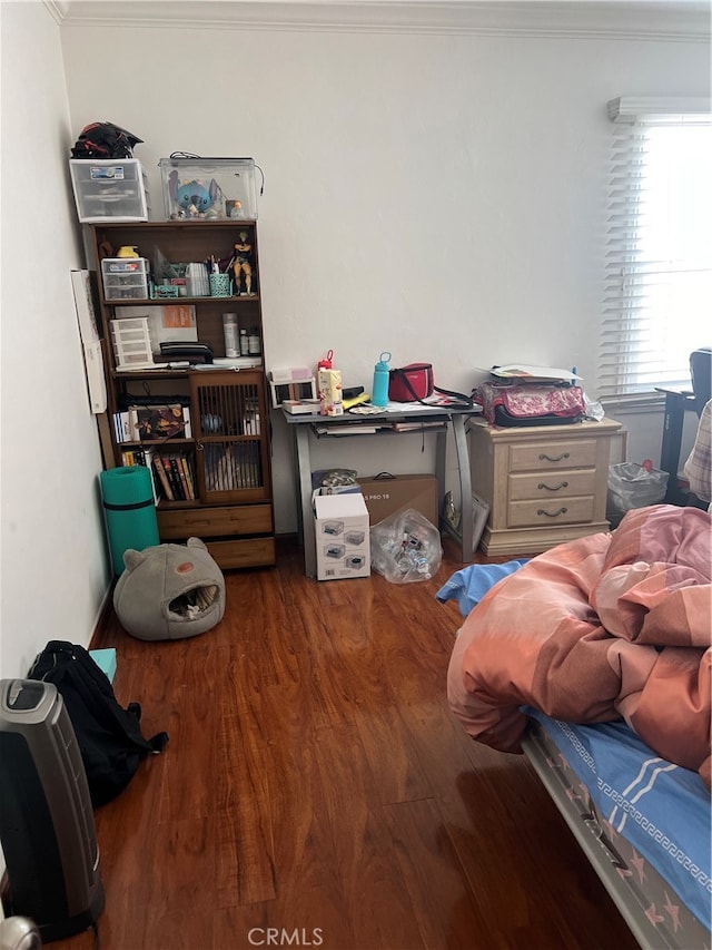 bedroom featuring ornamental molding and hardwood / wood-style floors