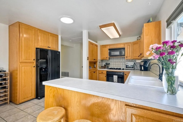 569 Prado Verde, San Marcos, CA 92069 - kitchen featuring kitchen peninsula, decorative backsplash, sink, and black appliances