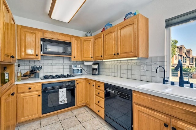 569 Prado Verde, San Marcos, CA 92069 - kitchen with backsplash, a healthy amount of sunlight, light tile patterned floors, and black appliances