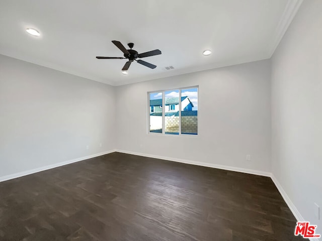 spare room with ceiling fan, dark wood-type flooring, and ornamental molding