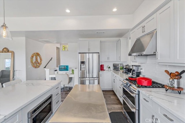 kitchen with white cabinetry, stainless steel appliances, hanging light fixtures, and dark wood-type flooring