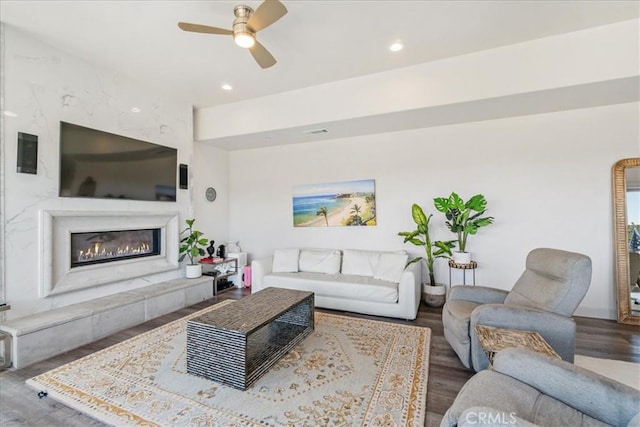 living room with hardwood / wood-style floors and ceiling fan