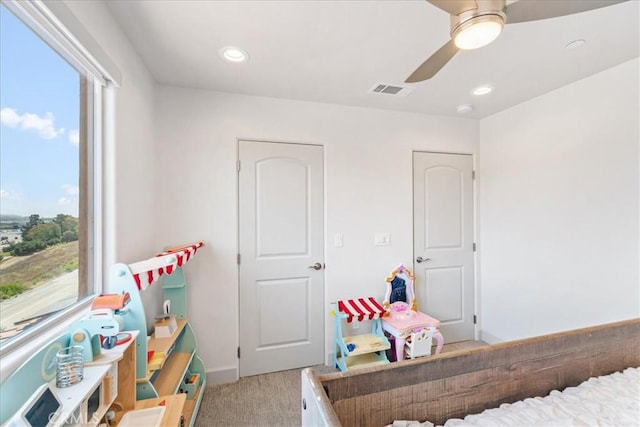 carpeted bedroom with ceiling fan