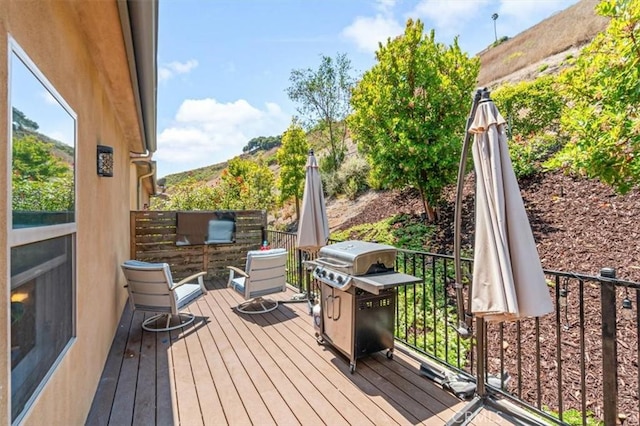 wooden terrace featuring area for grilling