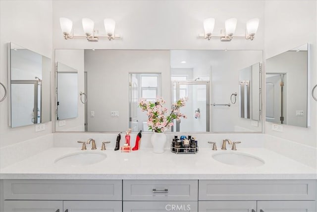 bathroom with vanity and a shower with door